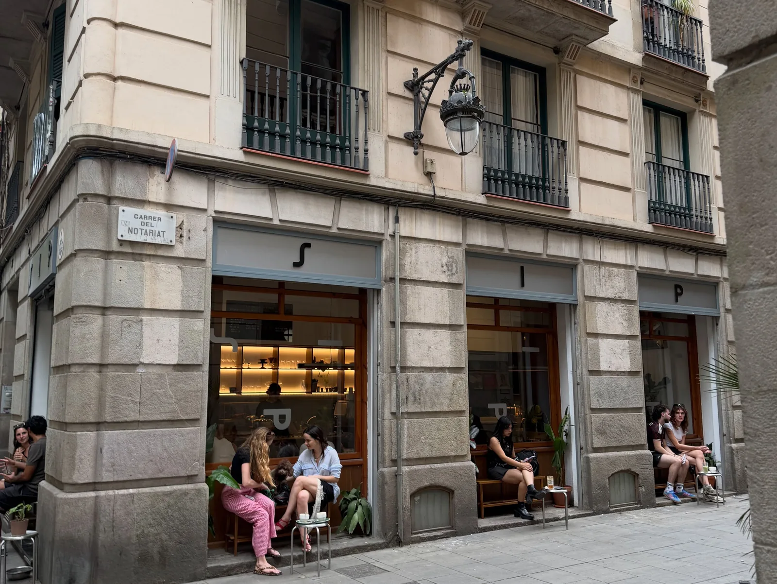 A street café in Barcelona, people sitting on the step