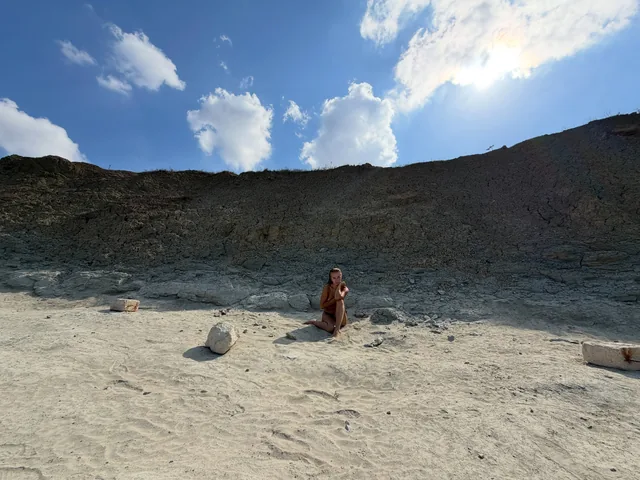 White sand under a wall of dark earth.