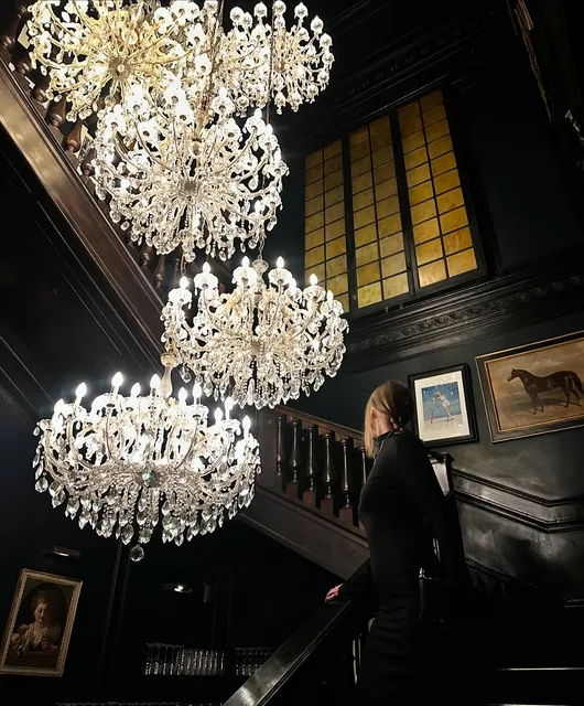 Chandeliers and a red staircase