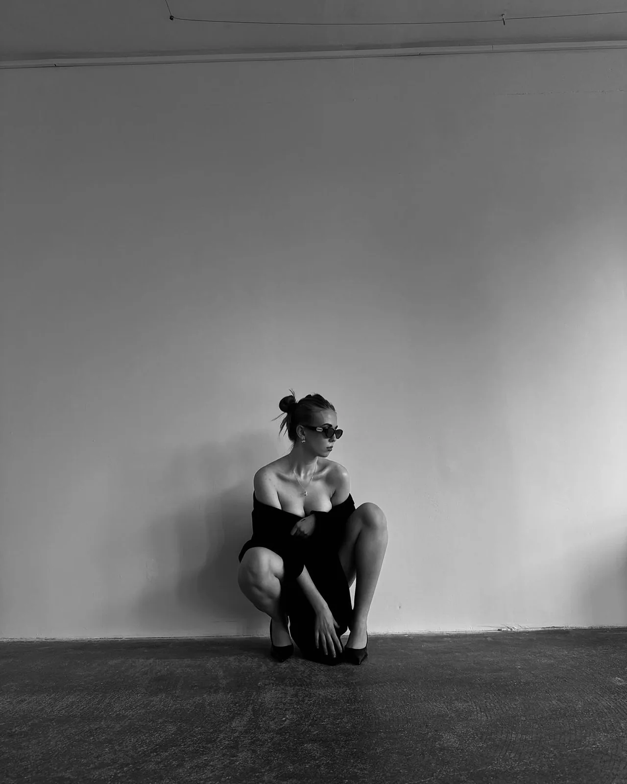 Studio, crouching in a black jacket